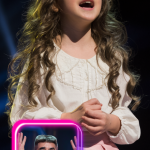 You wont believe what just happened, This young girl took the stage and unleashed a voice so powerful it left everyone in shock, Even Simon Cowell, known for his razor sharp critiques, was stunned, he actually stopped her mid song, refusing to believe that voice was coming from her, What happens next will leave you speechless